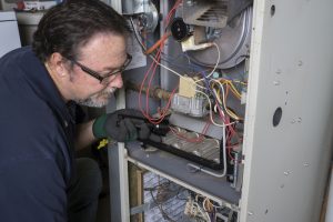 technician-looking-at-furnace